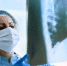 Female doctor examining patient's chest X-ray at the hospital. - Газета Новое Знамя